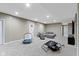 Spacious finished basement with a gray sectional sofa, recreation area and recessed lighting at 6107 Flagler Ln, Brownsburg, IN 46112