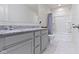 Bathroom featuring a double vanity with gray cabinets and a marble tile floor and shower at 6107 Flagler Ln, Brownsburg, IN 46112