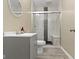 Bathroom featuring a stylish gray vanity, a walk-in shower with glass doors, and modern fixtures at 6107 Flagler Ln, Brownsburg, IN 46112