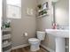 Neat half bathroom with pedestal sink and modern decor at 6107 Flagler Ln, Brownsburg, IN 46112