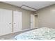 Carpeted bedroom with three doors and neutral paint offers privacy and ample storage at 6107 Flagler Ln, Brownsburg, IN 46112