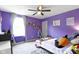 Bright and cheerful bedroom with purple walls, a ceiling fan, and whimsical decor for a space at 6107 Flagler Ln, Brownsburg, IN 46112