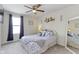 Comfortable bedroom features a ceiling fan, neutral decor, and a window with curtains for natural light at 6107 Flagler Ln, Brownsburg, IN 46112