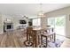 Elegant dining area with a wooden table and seamless access to the living room and outdoor spaces at 6107 Flagler Ln, Brownsburg, IN 46112
