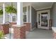 Inviting front porch with classic columns, brick accents, and a welcoming 'hello' door mat at 6107 Flagler Ln, Brownsburg, IN 46112
