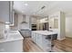 Modern kitchen features gray cabinets, stainless appliances, a center island with barstool seating, and stylish countertops at 6107 Flagler Ln, Brownsburg, IN 46112
