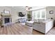 Cozy living room with stone fireplace, plush seating, and large windows that bring the outside in at 6107 Flagler Ln, Brownsburg, IN 46112
