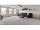 Spacious living room features a large sofa, ceiling fan, and several windows providing ample natural light at 6107 Flagler Ln, Brownsburg, IN 46112