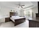 A spacious primary bedroom features a tray ceiling, a ceiling fan, and large windows at 6107 Flagler Ln, Brownsburg, IN 46112