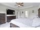 Spacious primary bedroom features tray ceilings, a ceiling fan and an adjacent bathroom at 6107 Flagler Ln, Brownsburg, IN 46112