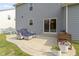 Inviting patio area offers comfortable seating, a grill, and views of the backyard and lush landscaping at 6107 Flagler Ln, Brownsburg, IN 46112