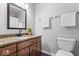 Bathroom featuring granite countertop, vanity with dark wood cabinets, and white fixtures at 6133 Buttonwood Dr, Noblesville, IN 46062