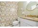Charming powder room with granite counters, patterned wallpaper, and decorative fixtures at 6133 Buttonwood Dr, Noblesville, IN 46062