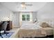 Comfortable bedroom with neutral walls, hardwood floors, ceiling fan, and a large window at 6133 Buttonwood Dr, Noblesville, IN 46062