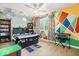 Fun bedroom with colorful geometric wall art, bookcase, and cloud-themed lighting at 6133 Buttonwood Dr, Noblesville, IN 46062