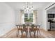 Bright dining room with modern chandelier, stylish table and chairs, and large window at 6133 Buttonwood Dr, Noblesville, IN 46062