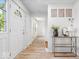 Bright entryway featuring hardwood floors, white walls, decorative art, and a modern console table at 6133 Buttonwood Dr, Noblesville, IN 46062