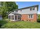 Two-story home featuring a brick facade, sunroom, neutral siding, and well-kept lawn at 6133 Buttonwood Dr, Noblesville, IN 46062