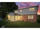 Two-story home featuring a brick facade, sunroom, neutral siding, and well-kept lawn at 6133 Buttonwood Dr, Noblesville, IN 46062