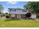 Charming two-story home with brick and vinyl exterior, landscaped yard, and inviting front entrance at 6133 Buttonwood Dr, Noblesville, IN 46062