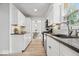 Bright kitchen features stainless steel appliances, granite counters, white cabinets, and wood-look flooring at 6133 Buttonwood Dr, Noblesville, IN 46062