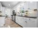 Modern kitchen with white cabinetry, stainless steel appliances, subway tile backsplash, and wood-look floors at 6133 Buttonwood Dr, Noblesville, IN 46062