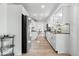 Bright kitchen features stainless steel appliances, granite counters, white cabinets, and wood-look flooring at 6133 Buttonwood Dr, Noblesville, IN 46062