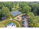 Aerial view of community playground, tennis courts, parking lot and the community pool in the background at 6133 Buttonwood Dr, Noblesville, IN 46062