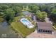 Aerial view of a community pool with beach access, tennis courts, parking lot, and playground at 6133 Buttonwood Dr, Noblesville, IN 46062