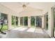 Enclosed sunroom with tile flooring, sliding glass doors, and white paneled ceiling at 6133 Buttonwood Dr, Noblesville, IN 46062