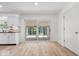 Bright sunroom with white trim, wood-look floors, white paint, and sliding glass doors to the patio at 6133 Buttonwood Dr, Noblesville, IN 46062