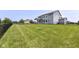 Large backyard featuring a lush lawn, black aluminum fencing and privacy from neighbors at 6160 Hardwick Dr, Whitestown, IN 46075