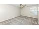 This bedroom features plush gray carpeting, a ceiling fan, and a bright window at 6160 Hardwick Dr, Whitestown, IN 46075