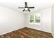 This bedroom features durable, hardwood flooring and a ceiling fan at 6160 Hardwick Dr, Whitestown, IN 46075