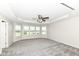 Spacious bedroom with neutral carpet, tray ceiling, ceiling fan, and plenty of natural light at 6160 Hardwick Dr, Whitestown, IN 46075
