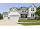 Charming two-story home with a three-car garage, stone accents, and a well-maintained lawn at 6160 Hardwick Dr, Whitestown, IN 46075