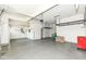 Spacious garage with epoxy floor, overhead storage racks, and ample room for vehicles and storage at 6160 Hardwick Dr, Whitestown, IN 46075
