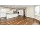 Open-concept kitchen with stainless steel appliances, granite countertops, and hardwood floors at 6160 Hardwick Dr, Whitestown, IN 46075