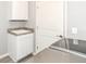 This laundry room has a utility sink, cabinets, and modern appliances at 6160 Hardwick Dr, Whitestown, IN 46075