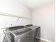 This laundry room has tile floors and modern washer and dryer at 6160 Hardwick Dr, Whitestown, IN 46075