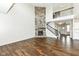 Inviting living room featuring hardwood floors, soaring ceilings, a stone fireplace, and an open staircase at 6160 Hardwick Dr, Whitestown, IN 46075