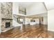 Spacious living room featuring a stone fireplace, hardwood floors, and an open floor plan at 6160 Hardwick Dr, Whitestown, IN 46075