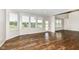 Sunlit living room with hardwood floors, large windows, and plenty of natural light at 6160 Hardwick Dr, Whitestown, IN 46075