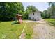 Backyard features a play structure with a slide, lush green grass, and mature trees at 640 Shady Creek Ct, Greenwood, IN 46142