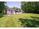 Lush backyard featuring mature trees and a patio set, perfect for outdoor relaxation and dining at 640 Shady Creek Ct, Greenwood, IN 46142