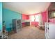 Stylish bedroom with an elevated platform bed, large windows and bright pink and turquoise walls at 640 Shady Creek Ct, Greenwood, IN 46142