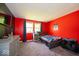Bright bedroom featuring vibrant red walls, a window with drapes, and a bed with colorful bedding at 640 Shady Creek Ct, Greenwood, IN 46142