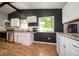 Modern kitchen with sleek countertops, white cabinets, and a bright window overlooking the yard at 640 Shady Creek Ct, Greenwood, IN 46142
