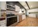 Bright kitchen featuring stainless steel appliances, white cabinets, and wood-look flooring at 640 Shady Creek Ct, Greenwood, IN 46142