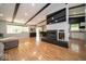 Open-concept living room with fireplace, television, and updated lighting at 640 Shady Creek Ct, Greenwood, IN 46142